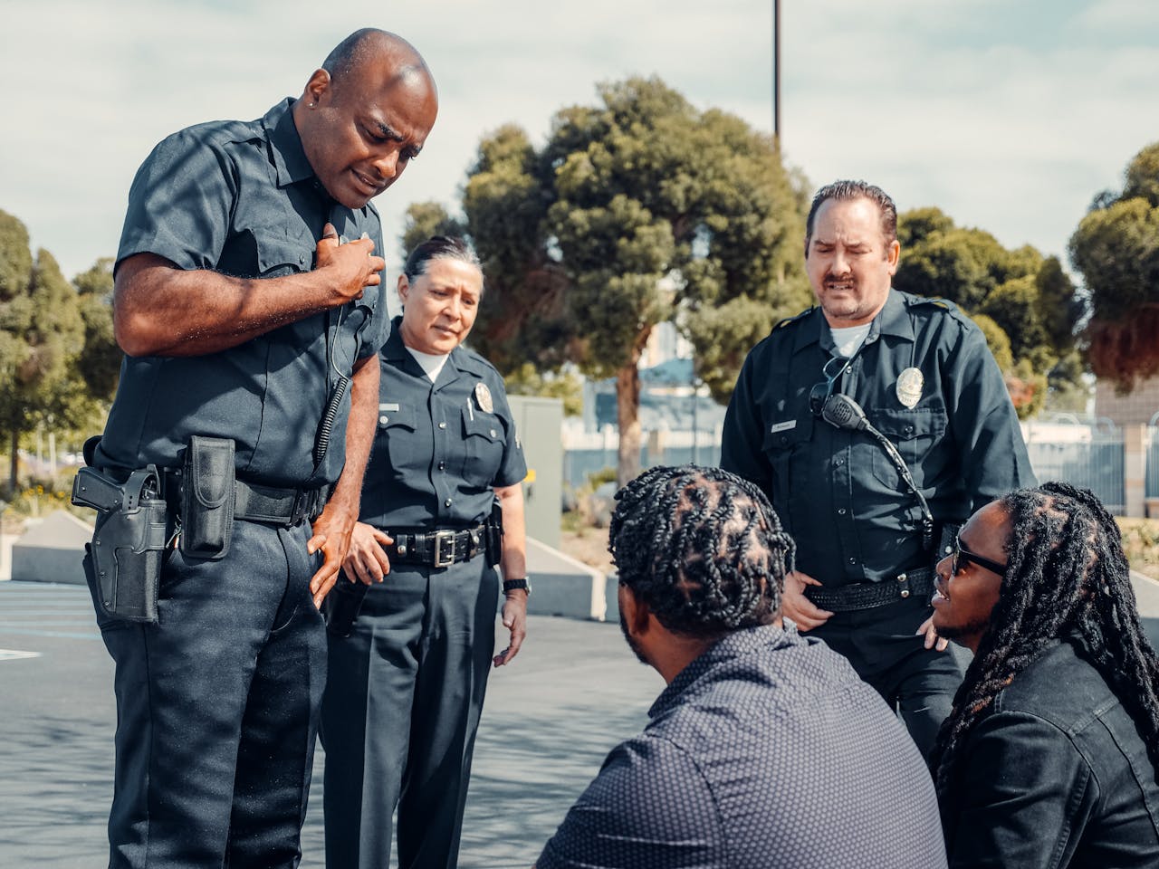 Police Officers Talking to Two Men on the Street